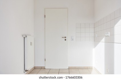 Empty Room With Tiles On The Wall And Door As A Kitchen Or Bathroom At Home