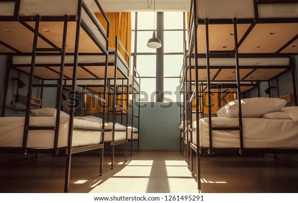 Empty room with twin beds. Metal bed hostel\
with minimalistic\
decoration.