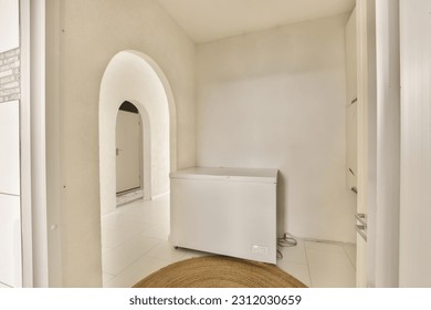 an empty room with a white refrigerator and washer on the floor in front of the door to the bathroom - Shutterstock ID 2312030659