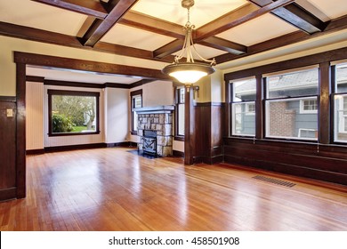 Empty room with wood paneled walls and coffered ceiling.  View of family room with old fireplace with stone trim.  Northwest, USA