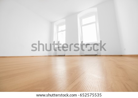 empty room, wooden floor in new apartment, blurred