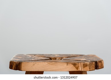 Empty rough wooden table top of old stool in blur on a gray background. Side cut close-up. Photo with for copy space. - Shutterstock ID 1312024907