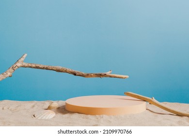 Empty round beige platform podium and dry tree twigs on white beach sand background. Minimal creative composition background for cosmetics or products presentation with blue background. Front view - Powered by Shutterstock