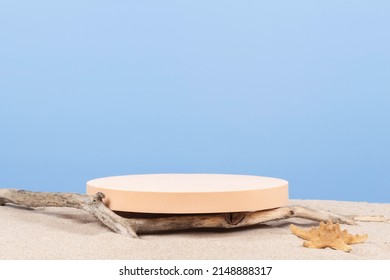 Empty round beige platform podium and dry tree twigs on white beach sand background. Minimal creative composition background for cosmetics or products presentation. Front view