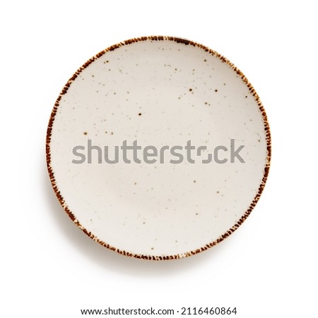 Empty round dinner plate isolated on a white background. White speckled plate with brown border cutout. Modern porcelain crockery for food design. Dishes and tableware concept. Top view.