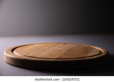 Empty Round Pizza Board On Dark Table

