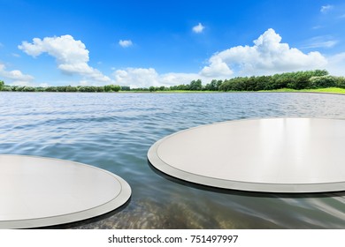 Empty round square floor and lake nature landscape in front of green forest