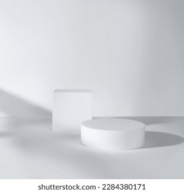 Empty round and square podium with window shadow for product presentation