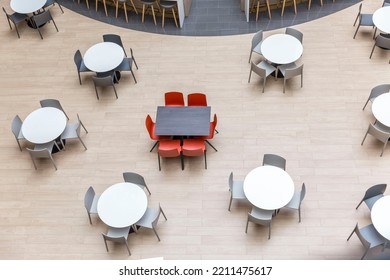 Empty Round Tables And Chairs At A Food Court In A Shopping Mall. View From Above.