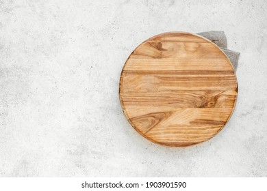 Empty Round Wooden Board On White Kitchen Table, Top View, Copy Space. Wooden Platter, Copy Space.