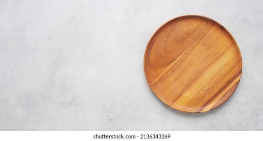 Empty Round Wooden Plate On Gray Cement Table Background, Banner With Copy Space, Blank Wood Tray For Food Display Montage, Template, Mock Up, Top View, Flat Lay