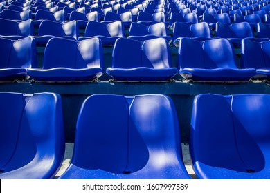 Empty rows with blue seats on a stadium 