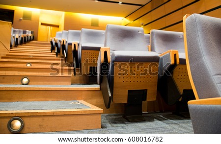 Empty rows of chairs in theater.