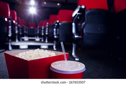 Empty rows of red seats with pop corn and drink on the floor at the cinema