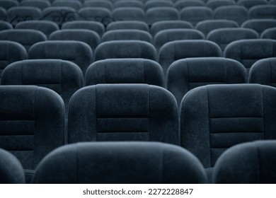 Empty rows of seats in the hall for a large number of people. Cinema and theatre hall for watching performances.