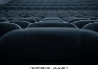 Empty rows of seats in the hall for a large number of people. Cinema and theatre hall for watching performances.