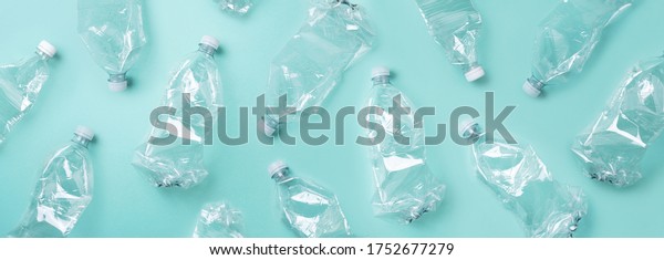 Empty\
rumpled used plastic bottle on blue background. Top view, copy\
space. Pollution, environmental protection concept. Reuse garbage,\
recycle, plastic free. Earth, world water\
day.