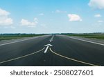 empty runway on schiphzl airport on a sunny day with a blue sky