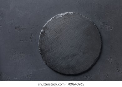 Empty rustic black slate stone plate on dark background, copy space, top view - Powered by Shutterstock