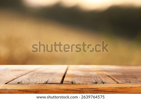 Empty rustic table in front of countryside background. product display and picnic concept
