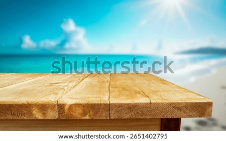 Empty rustic wooden table with copy space on sandy beach and sea and sky background. The image captures the essence of sunny summer day by the coast, evoking feelings of relaxation and calmness.