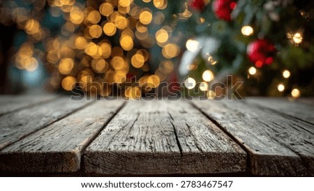 An empty rustic wooden table in the foreground with a bokeh effect of warm Christmas tree lights in the background.