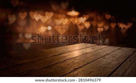 Empty rustic wooden table top with blurred heart shaped lights in the background for a romantic product display or festive holiday atmosphere