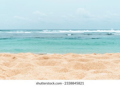 Empty sandy beach in the background with a blurry summer sea.