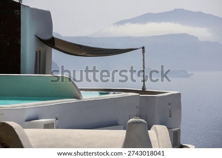 empty santorini terrace with infinity pool and sea view