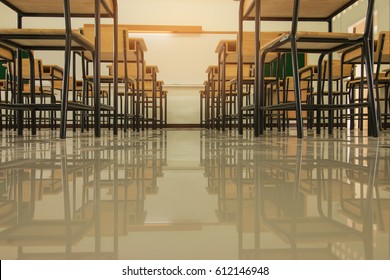 Empty School classroom with desks chair wood, and green board in high school Thailand, vintage tone education concept