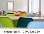 Empty school dining room or cafe with colorful chairs. Selective focus.