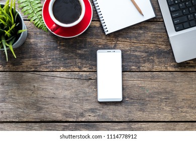 empty screen smartphone and computer on wooden table top view. with clipping path