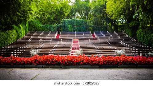 Empty seats in the audience area at an outdoor theater