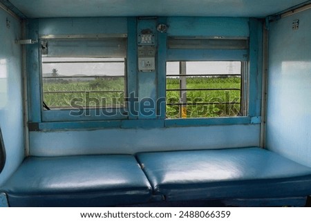 Empty seats and berths inside a second class sleeper compartment in a train run by the Indian Railways. Inside view of AC coaches Passenger train compartment. Compartment and berth with bed-linen pack