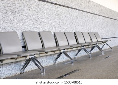 Empty Seats At A Business Building With White Wall, A Row Of Waiting Chairs, Waiting Area With Chair Row In The Office Seating Area Against A Wall