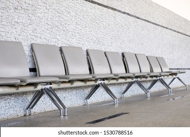 Empty Seats At A Business Building With White Wall, A Row Of Waiting Chairs, Waiting Area With Chair Row In The Office Seating Area Against A Wall