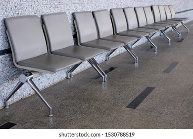 Empty Seats At A Business Building With White Wall, A Row Of Waiting Chairs, Waiting Area With Chair Row In The Office Seating Area Against A Wall