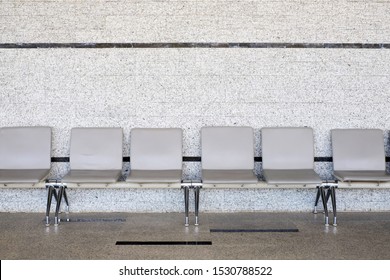 Empty Seats At A Business Building With White Wall, A Row Of Waiting Chairs, Waiting Area With Chair Row In The Office Seating Area Against A Wall