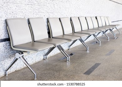 Empty Seats At A Business Building With White Wall, A Row Of Waiting Chairs, Waiting Area With Chair Row In The Office Seating Area Against A Wall