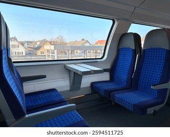 Empty seats inside a regional train with a view through the window in Europe.