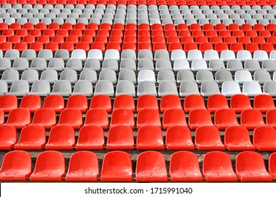 Empty seats in the stands of the arena or auditorium. Rows of red and white stadium seats without spectators. The concept of the abolition of sports and mass entertainment events - Shutterstock ID 1715991040