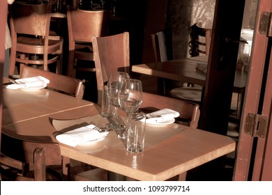 Empty served restaurant table . Open door in summer season