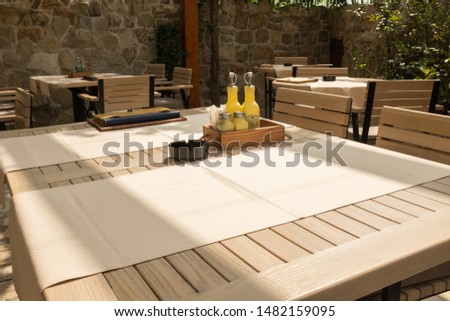 Empty set table in a restaurant, open air garden, close up, no people, empty due to global pandemic outbreak of Coronavirus, COVID-19 corona virus disease crisis, isolation and lockdown, quarantine