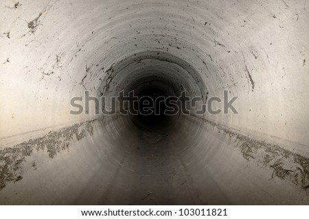 Empty sewer channel dark interior, pipeline thick tube inside