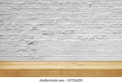 Empty Shelf On White Brick Wall