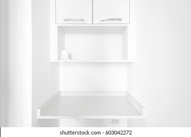 Empty Shelf And Small Closet In Small Storage Room Or Laundry Room, Tight Space In An Apartment. White Furniture, All Built In Furniture.