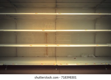 Empty shelves in store in Humble, Texas USA. Supermarket with empty shelves for goods. Vintage tone.
