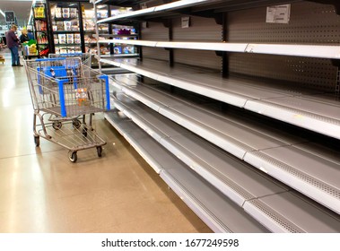 Empty shelves at a supermarket due to stockpiling during the coronavirus pandemic - Shutterstock ID 1677249598