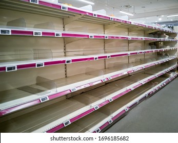 Empty shelves in supermarket store due to coronavirus covid-19 outbreak panic. Food supply shortage in Paris France