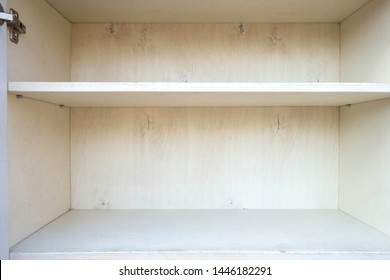 Empty Shelves In White Wooden Cupboard.